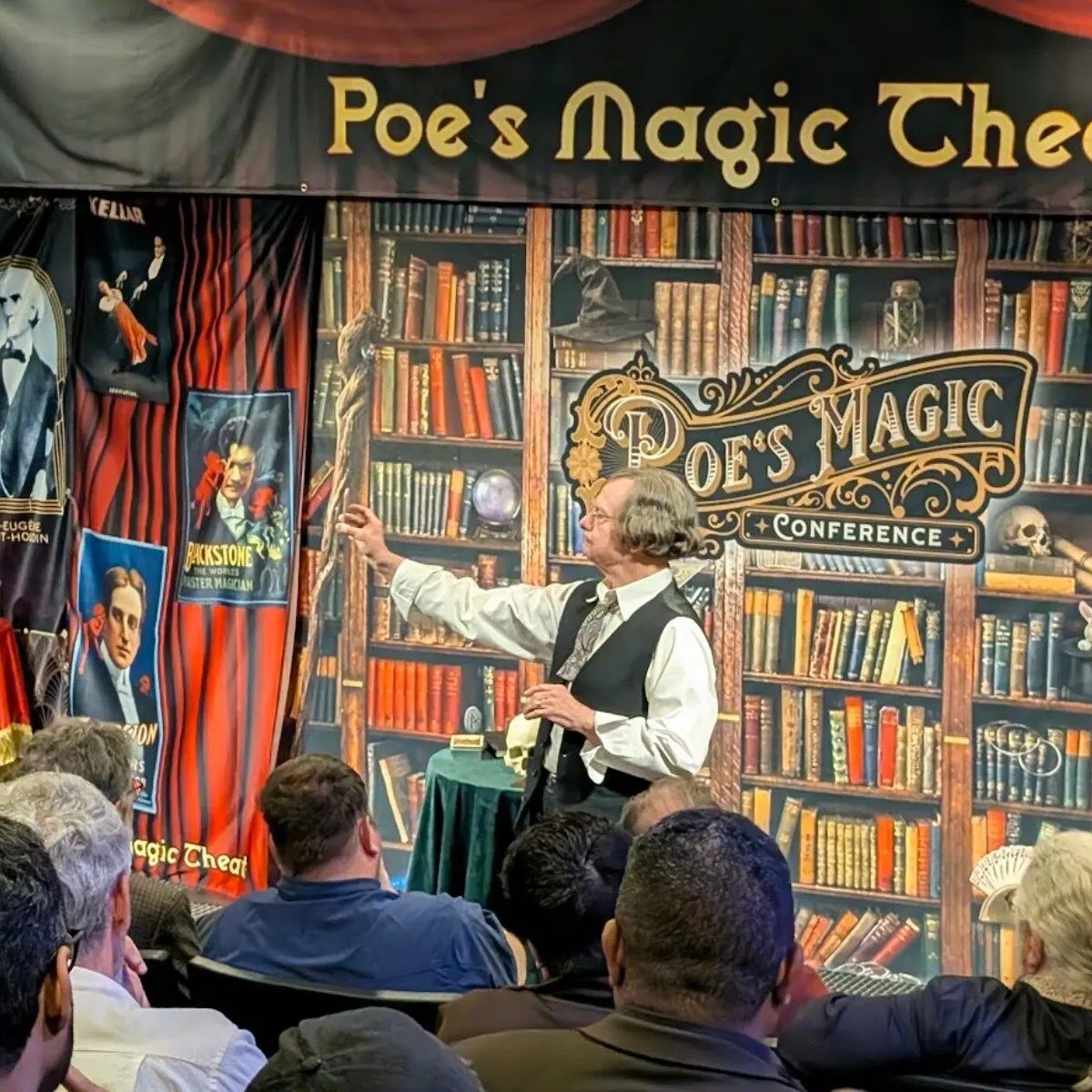 A theatrical magic lecture before an audience at Poe's Magic Conference