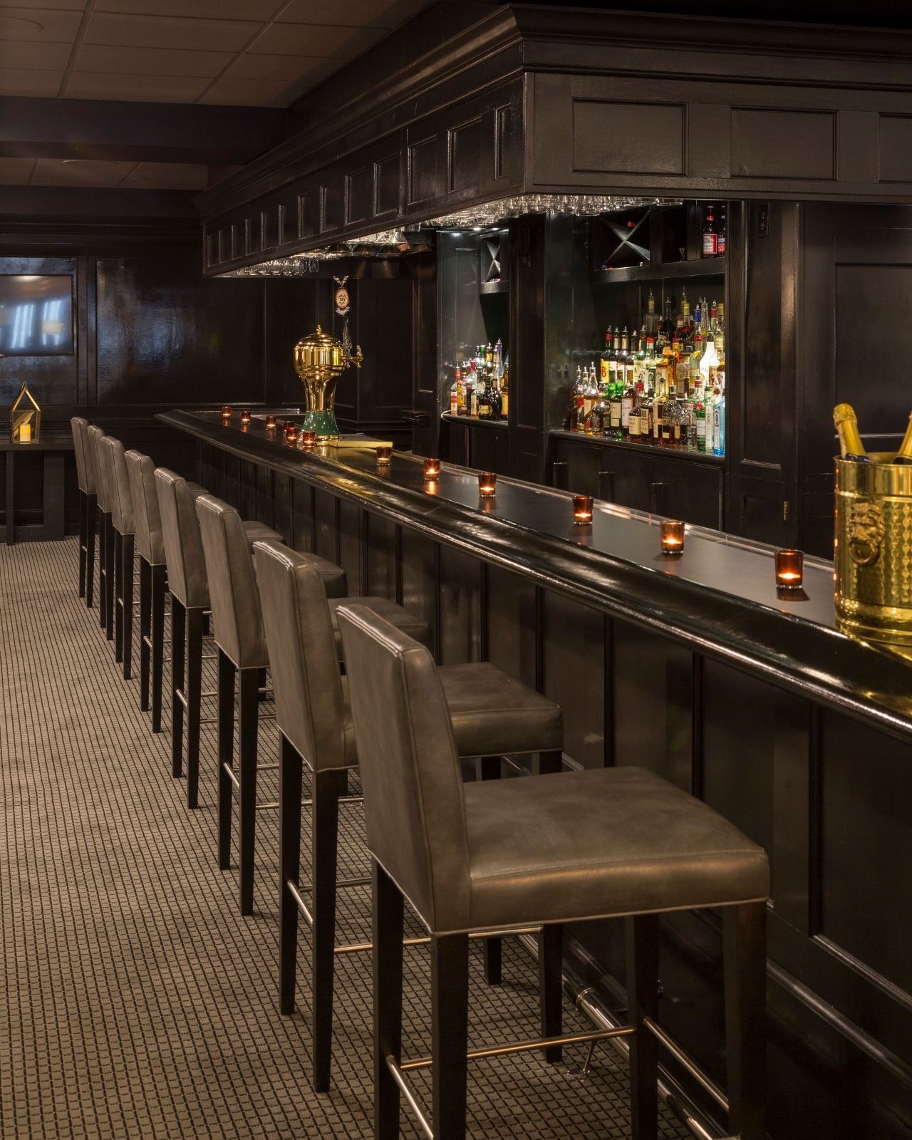 The long polished bar and candlelit seating inside LB Tavern